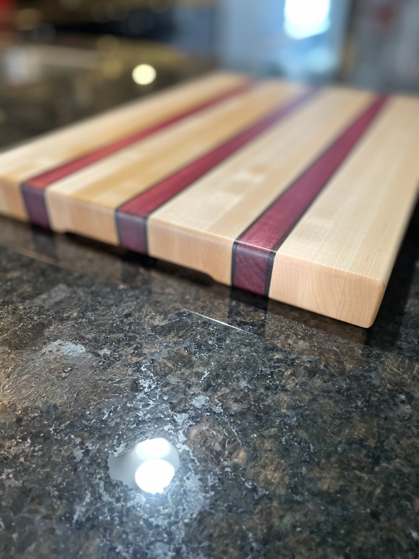 custom handmade edge grain maple purpleheart walnut wood cutting board, top/side view